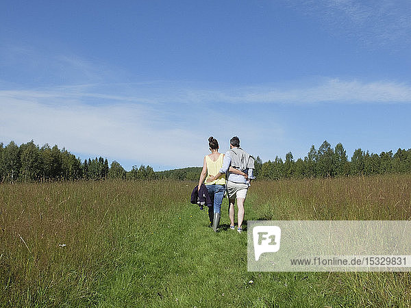 Couple walking in field
