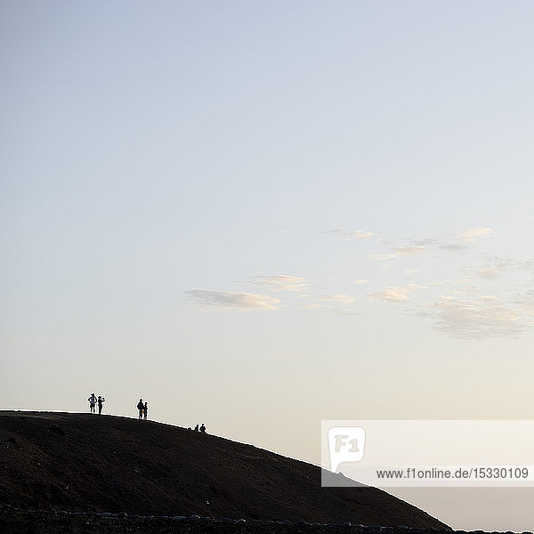 Silhouette of people on hill