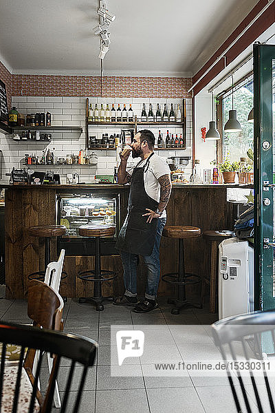 Mid adult man working in cafe