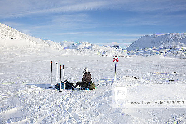 Woman resting on Kungsleden trail in Lapland Sweden