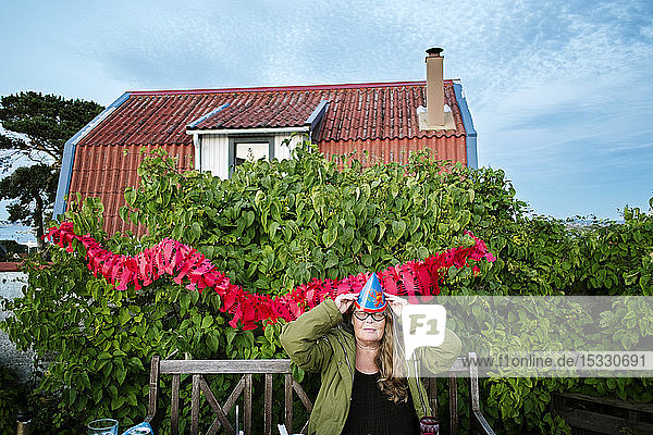 Mid adult woman having party in backyard