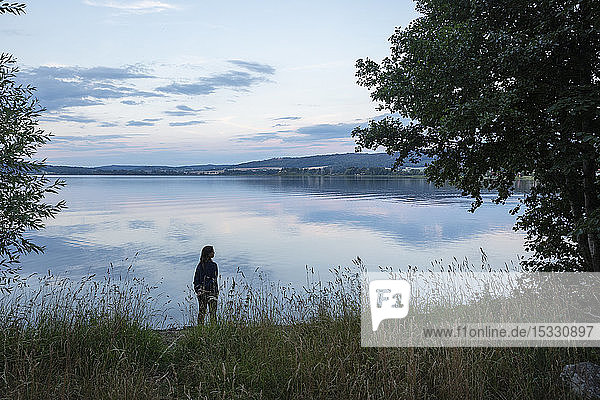 Woman standing by Lake Landsjon Sweden