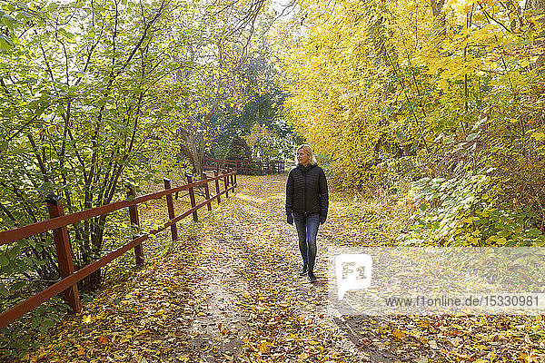 Mature woman walking in forest