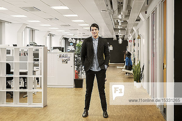 Young man standing in office