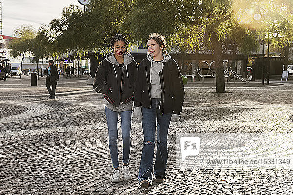 Teenage girls walking on cobblestone