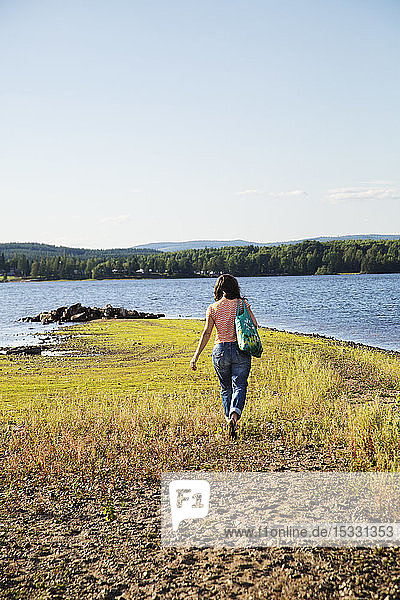 Woman walking by lake