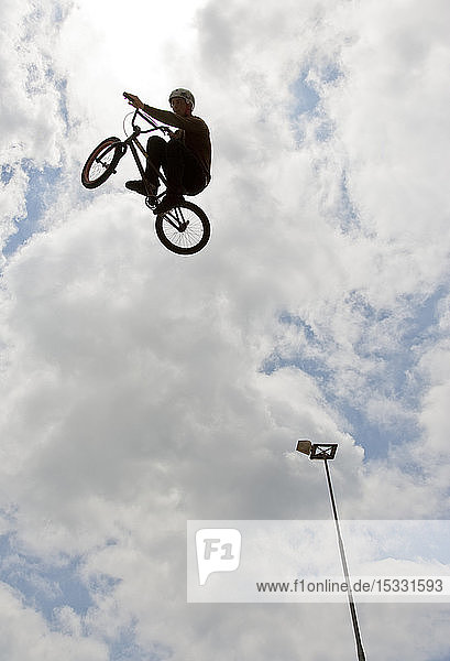 Side view of man doing bmx trick