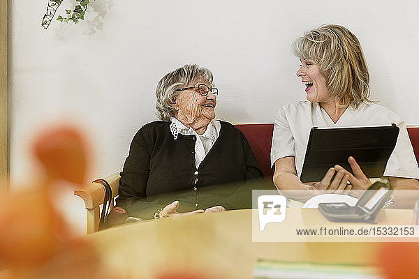 Senior woman learning to use tablet PC