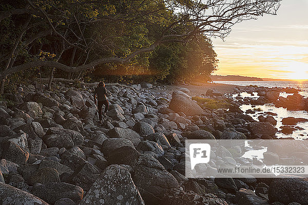 Man on rocks at sunset