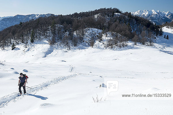 Italy  Lombardy  Orobie Alps Regional Park  snowshoeing in Taleggio Valley  bg.: Mt. Resegone