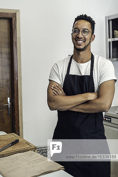 Portrait of man standing in commercial kitchen