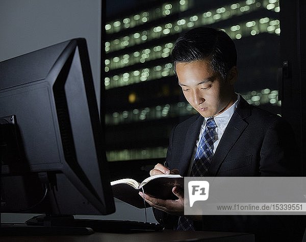 Young Japanese businessman working late at night