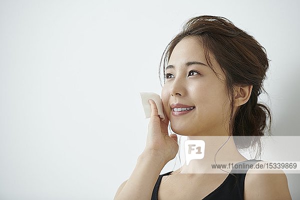 Studio portrait of attractive young Japanese woman