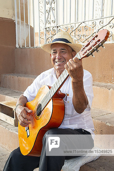Local man singing and playing his guitar in the Plaza Mayor of Trinidad  Cuba  West Indies  Caribbean  Central America