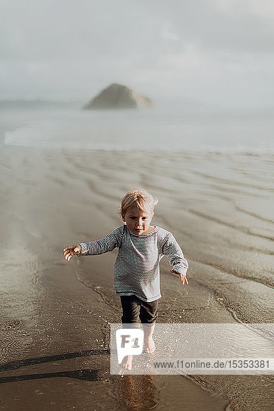 Toddler running on beach  Morro Bay  California  United States