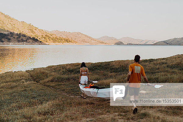 Couple carrying kayak to lake  Kaweah  California  United States