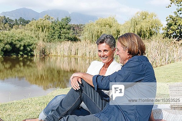 Couple relaxing by pond  Cape Town  South Africa