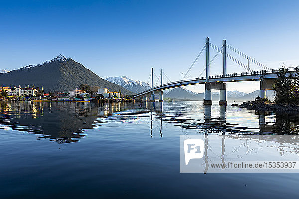 John O'Connell bridge reflected in the Sitka harbour and the town of Sitka in winter with Mount Versovia in the background; Sitka Alaska United States of America