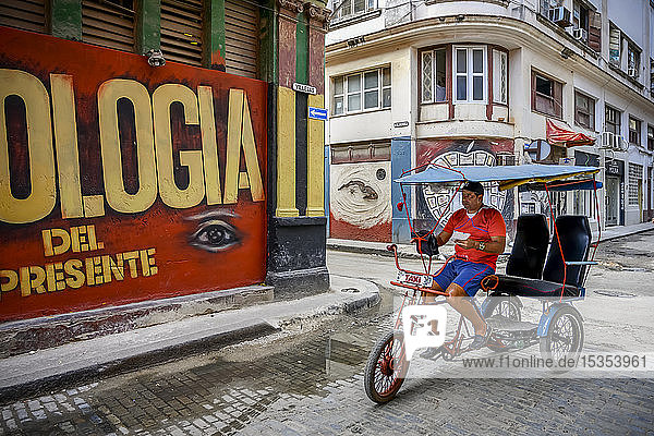 Mann auf einem Fahrradtaxi in den Straßen von Havanna; Havanna  Kuba