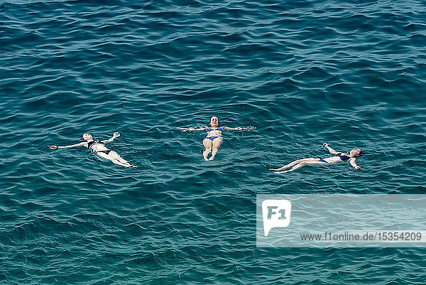 Young female tourists swimming in the Adriatic Sea; Rovinj  Croatia