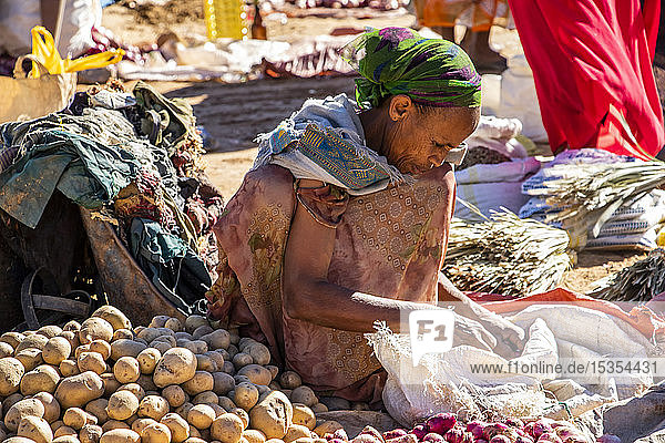 Ethiopian woman selling potatoes at the weekly market; Abreha we Atsbeha  Tigray  Ethiopia