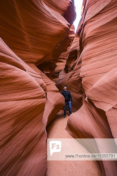 Man standing in a Slot Canyon known as Canyon X  near Page; Arizona  United States of America
