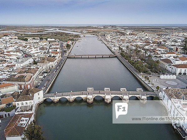 City view with roman bridge over Gilao river in old fishermen's town  Tavira  drone shot  Algarve  Portugal  Europe