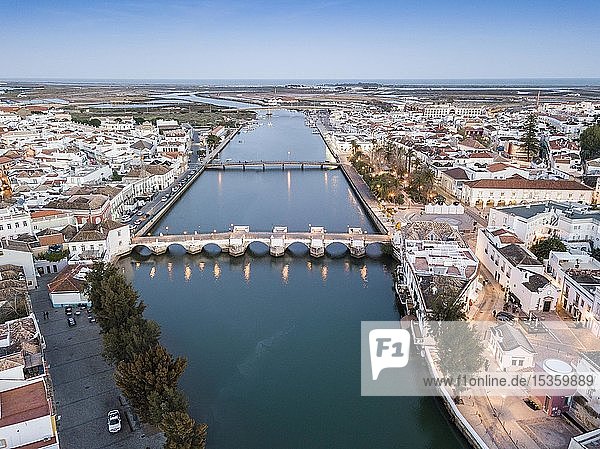 City view with roman bridge over Gilao river in old fishermen's town in the evening light  Tavira  drone shot  Algarve  Portugal  Europe
