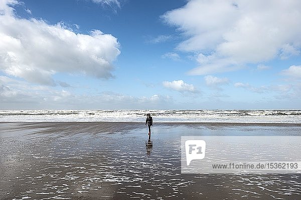 Young woman running to beach  North Sea  Zandvoort aan Zee  North Holland  Holland  Netherlands
