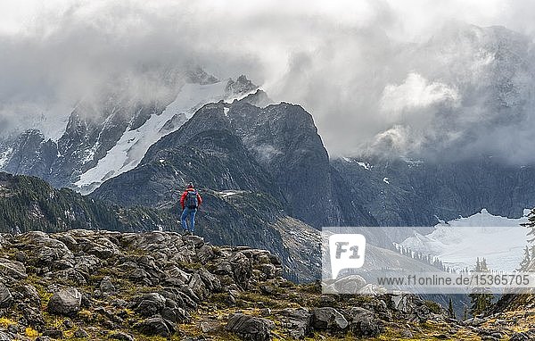 Female hiker with view on Mt. Shuksan with snow and glacier  cloudy sky  Mt. Baker-Snoqualmie National Forest  Washington  USA  North America