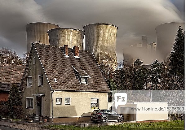 Residence in the Auenheim district in front of the steaming lignite-fired power plant Niederaussem  coal phase-out  Bergheim  North Rhine-Westphalia  Germany  Europe