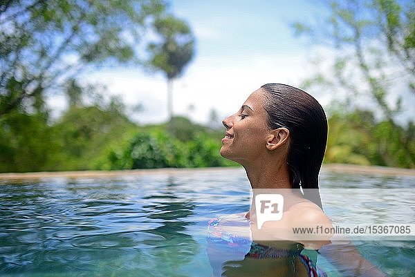 Young woman enjoying a bath in the swimming pool  Galle  Sri Lanka  Asia
