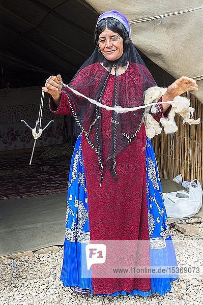 Qashqai woman spinning wool  Qashqai nomad camp  Fars Province  Iran  Asia