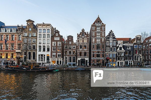 Historische Häuserreihe an einer Gracht in der Abenddämmerung  Amsterdam  Nordholland  Niederlande