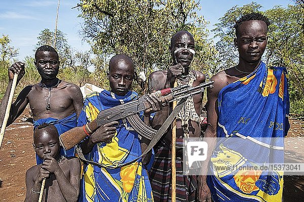 Men  from Mursi tribe  one with man with Kalashnikov  Mago National Park  Southern Nations Nationalities and Peoples' Region  Ethiopia  Africa