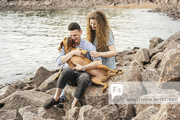 Young couple with dog at the beach