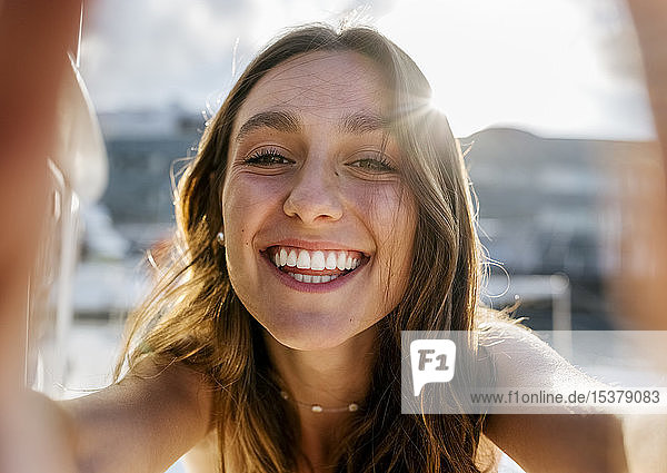 Young beautiful woman taking a selfie on a sailboat