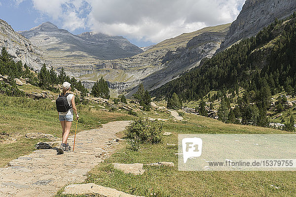 Rear view of woman walking on a trail in mountains  Ordesa national park  Aragon  Spain