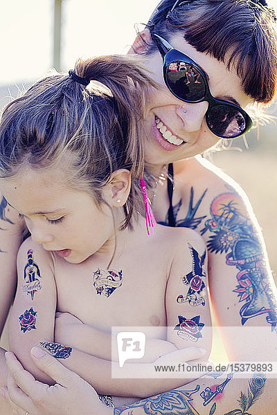 Mother and her daughter  with fake tattoos