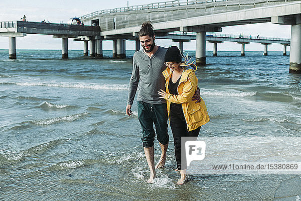 Couple walking at the beach in Heiligenhafen