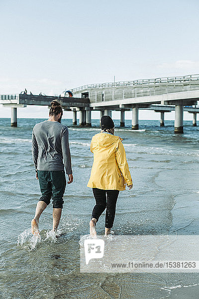 Couple walking at the beach in Heiligenhafen