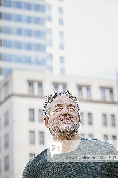 Portrait of confident mature man in the city looking up