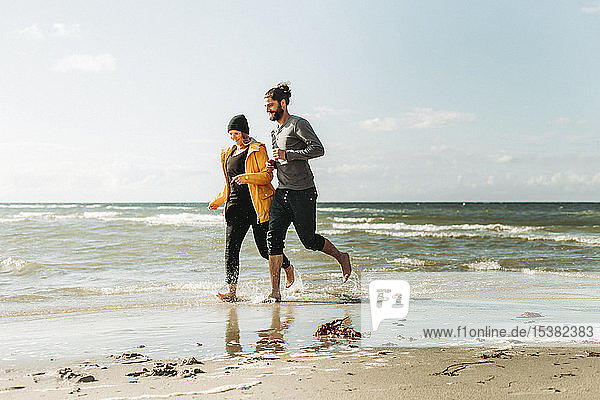Couple running at the beach in Heiligenhafen