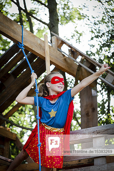 Superhero girl playing in a tree house