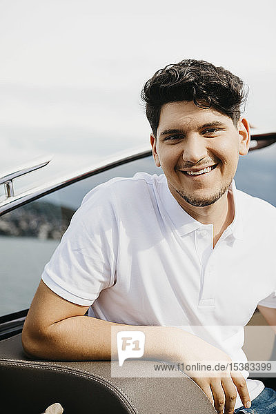 Portrait of happy man on a boat trip on a lake