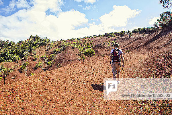 Hiker on red soil  Agulo  La Gomera  Canary Islands  Spain