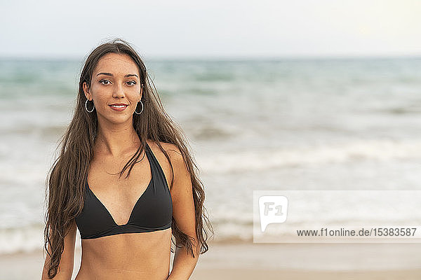 Portrait of beautiful young woman in bikini on the beach