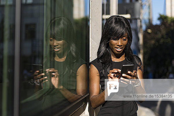 Businesswoman using smartphone in the city