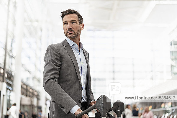 Businessman with luggage cart atb the airport