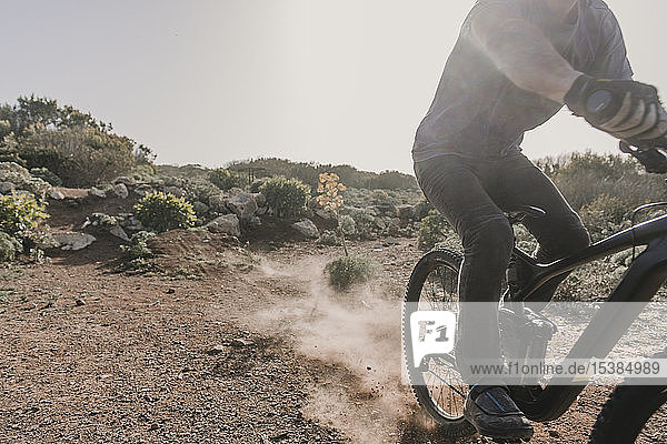 Spain  Lanzarote  partial view of mountainbiker on a trip in desertic landscape
